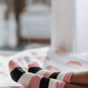 Relaxing scene of striped socks in a sunlit bedroom, perfect for cozy living themes.