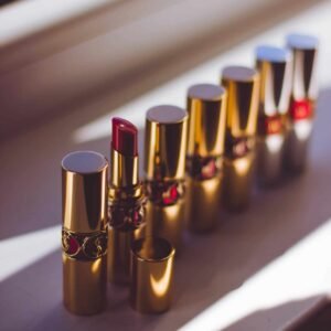 A stylish display of red lipsticks in gold tubes, capturing a chic and elegant look.